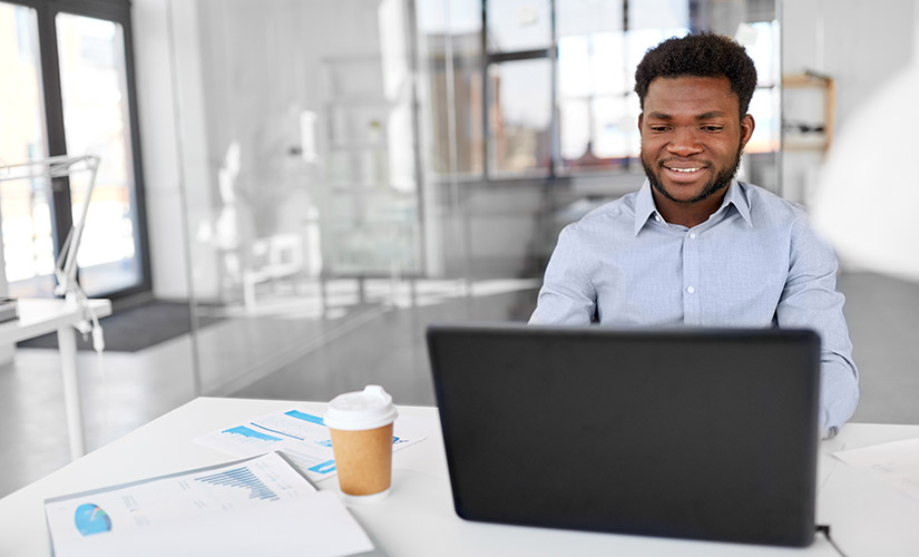 african american businessman with laptop at office bulk sms for marketing